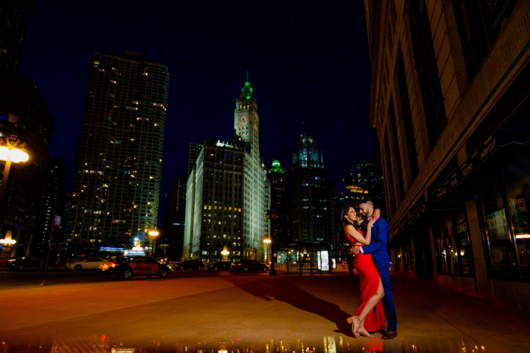 Destination engagement photos at night with Wrigley Building in the background 