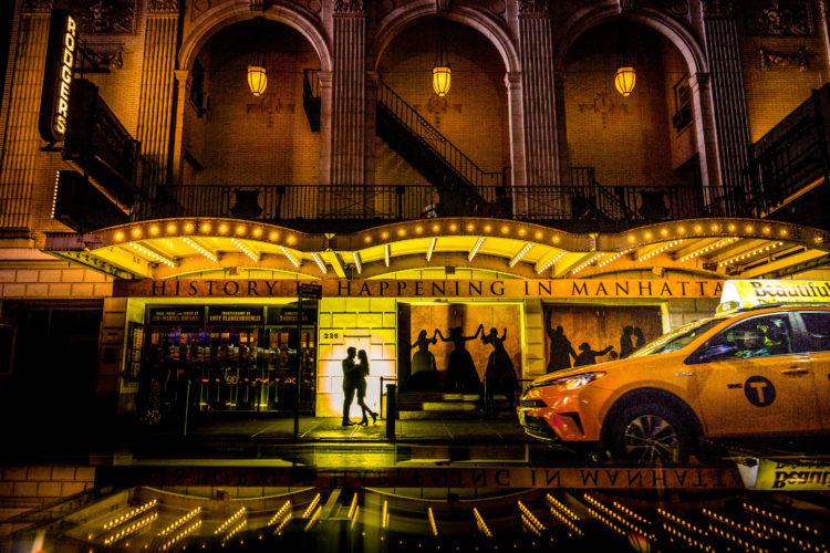 Destination Engagement photo session at night in front of Hamilton Musical Theater 