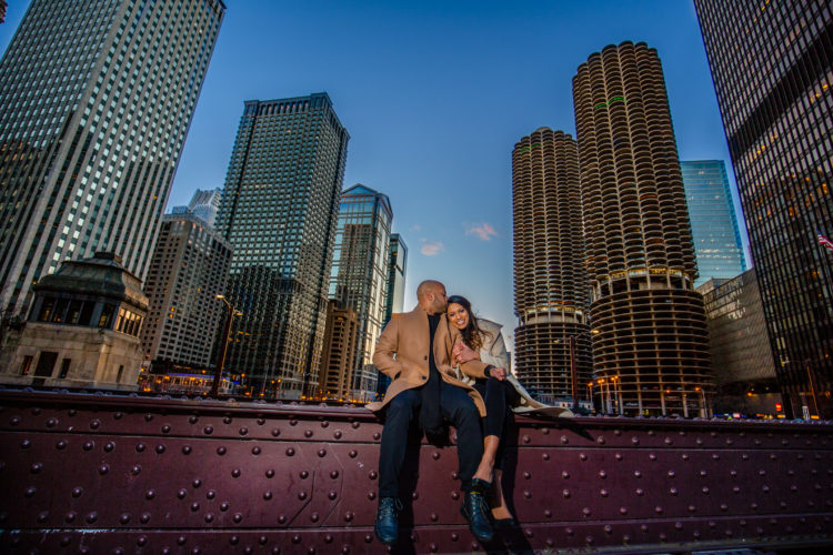 Couple destination engagement photo on Lasalle street Bridge in Chicago during sunset 