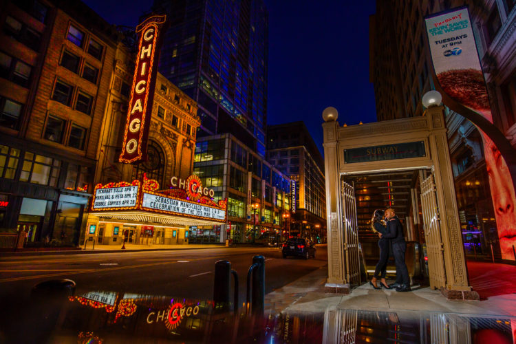 Destination engagement photo session in front of Chicago Theater at night