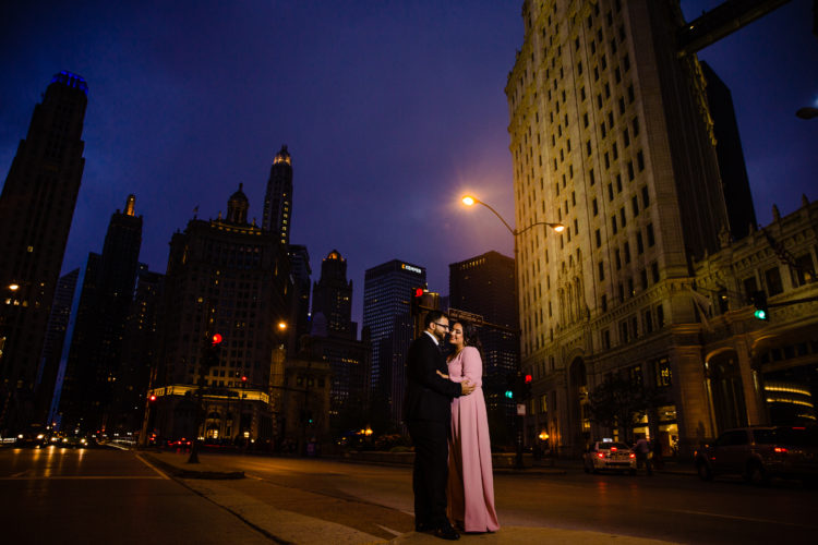 night shot of a couple in front of Wrigley Building in Chicago